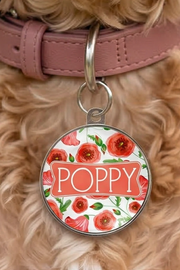 Poppy dog name tag on a dog collar with personalised floral pet ID tag visible