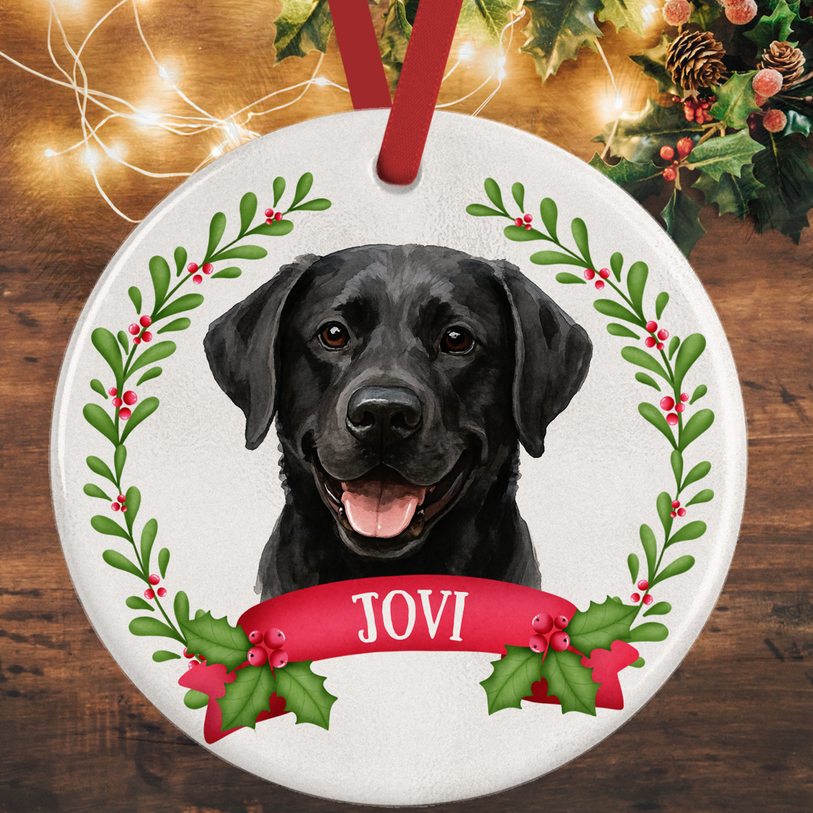 Round holiday decoration featuring black Lab illustration and red ribbon