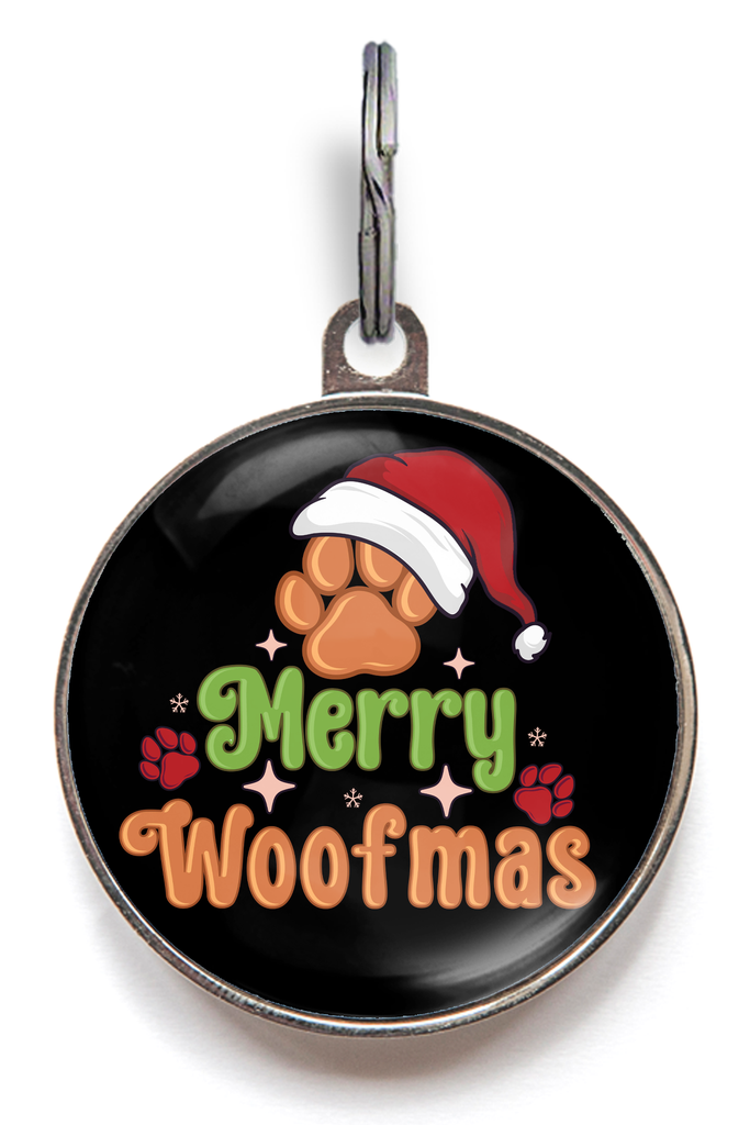 Merry Woofmas Christmas Pet Tag. A colourful Christmas tag, with a paw wearing a Santa hat and the words Merry Woofmas on a black background