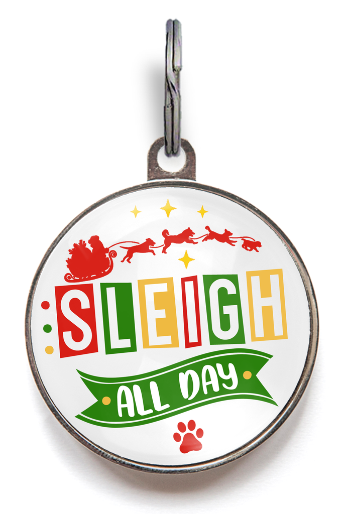 Christmas dog tag reading “Sleigh All Day” with Santa sleigh artwork