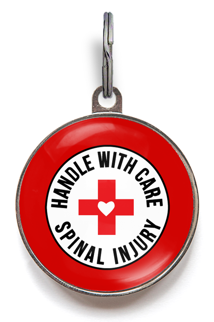 Spinal injury dog tag with the text “Spinal Injury - Handle With Care,” attached to a pet collar for dogs with mobility or back conditions